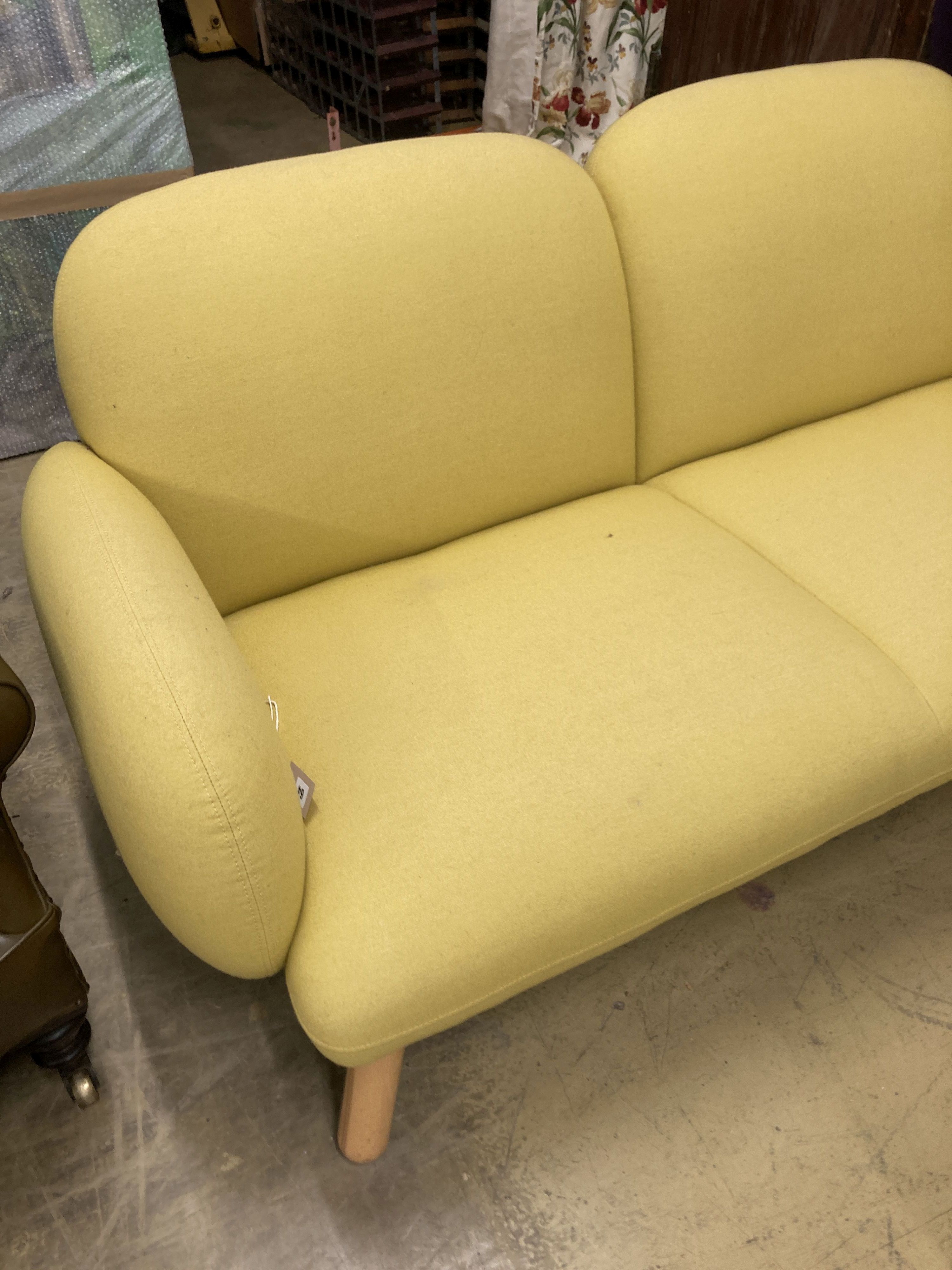 A contemporary pale yellow fabric two seater settee, length 160cm, depth 80cm, height 76cm